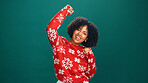 Christmas, happy and portrait of black woman in studio for tradition, festive or celebration. Excited, cheering and face of African female person with good news for xmas party by green background.