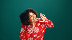 Excited, woman and announcement for Christmas, studio and awareness for holiday discount or festive. Green background, shout and attention for xmas special, December offer and black person with smile