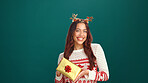 Christmas, portrait and happy woman with gift in studio for holiday celebration with mockup space. Smile, female person and present for xmas, festive tradition and giveaway box on green background