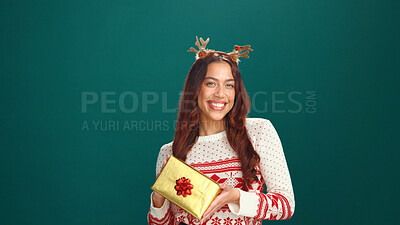 Buy stock photo Christmas, portrait and happy woman with gift in studio for holiday celebration with mockup space. Smile, female person and present for xmas, festive tradition and giveaway box on green background