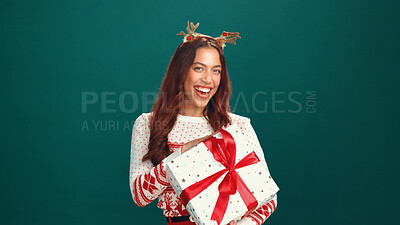 Buy stock photo Christmas, portrait or happy woman with gift box in studio for holiday celebration with mockup space. Smile, person and present for xmas, festive tradition or laugh with giveaway on green background