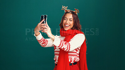 Buy stock photo Christmas, woman or happy with selfie in studio for holiday memory, festive fashion or online post. Mockup space, girl or smile with photography on green background for xmas party and profile picture