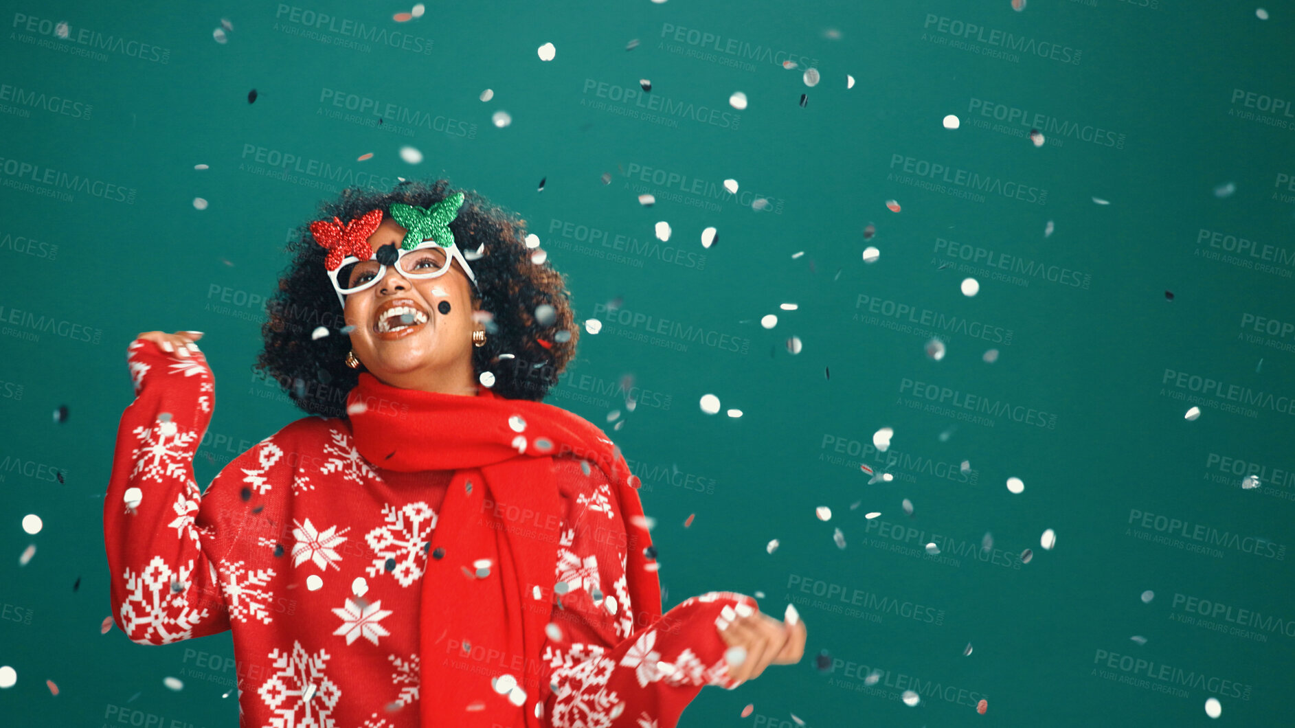 Buy stock photo Confetti, Christmas and woman in studio dance for party, festive season and holiday. Mockup space, December and person with decoration, glitter and energy for xmas celebration on green background