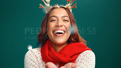 Buy stock photo Christmas, confetti and portrait of woman in studio for holiday season, celebration or smile. Festive event, xmas vacation and glitter with person on green background for space and December cheer