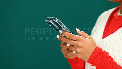 Buy stock photo Christmas, phone and hands of woman in studio with networking, communication or social media. Mockup space, xmas contact and person with cellphone for online, app or texting by green background.