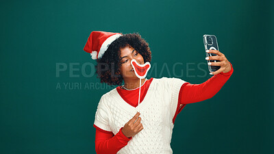 Buy stock photo Woman, Christmas and happy for selfie in studio with lips, emoji or hat with mockup space on background. Person, influencer and smile for photography, profile picture or social media for xmas holiday