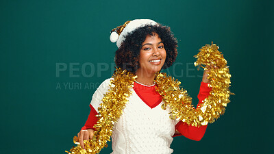 Buy stock photo Woman, Christmas tinsel and portrait in studio, happy and Santa hat with decoration on background. Girl, smile and festive celebration with xmas cap, mock up space and holiday season in Costa Rica