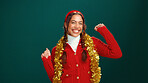 Woman, Christmas and portrait in studio, dance and gold tinsel for decoration on background. Girl, excited and happy for festive celebration with xmas jersey, mockup space or holiday season in Mexico