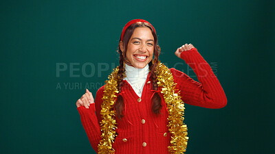 Buy stock photo Woman, Christmas and portrait in studio, dance and gold tinsel for decoration on background. Girl, excited and happy for festive celebration with xmas jersey, mockup space or holiday season in Mexico