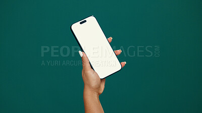Buy stock photo Woman, hands and phone screen with mockup in studio for online advertising on a green background. Female person, user or mobile smartphone with display for UI marketing, UX app or network on space