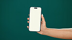 Hands, person and phone screen with mockup in studio for digital marketing, advertising space or UX. Mobile user, woman and smartphone display on green background for coming soon launch and promotion