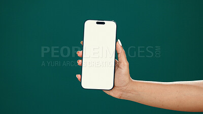 Buy stock photo Hands, person and phone screen with mockup in studio for digital marketing, advertising space or UX. Mobile user, woman and smartphone display on green background for coming soon launch and promotion