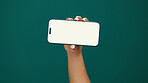 Hands, woman and phone screen with mockup in studio for digital marketing, advertising space or UX. Mobile user, person and smartphone display on green background for coming soon deal and promotion