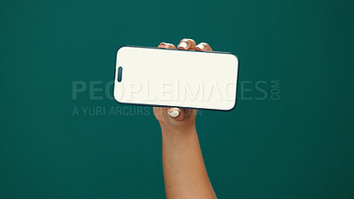 Buy stock photo Hands, woman and phone screen with mockup in studio for digital marketing, advertising space or UX. Mobile user, person and smartphone display on green background for coming soon deal and promotion