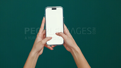 Buy stock photo Hands, smartphone and woman in studio, screen and social media on green background. Typing, mockup space and person with cellphone, internet and connection with network, email and message to contact