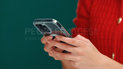 Buy stock photo Notification, cellphone and hands of woman in studio with networking, communication or social media. Space, contact and person with phone for online, mobile app or texting by green background.