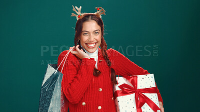 Buy stock photo Woman, Christmas and portrait in studio, gift bag and excited with sale, shopping or discount on background. Girl, smile and festive celebration at xmas, package and holiday season in Costa Rica