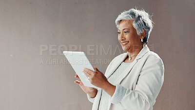 Buy stock photo Mature businesswoman, tablet and wall at office, smile and scroll with mockup space for contact on web. Person, happy and tech with application, typing and review for revenue report at finance agency