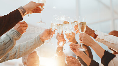 Buy stock photo Hands, champagne toast and sparkler at office, achievement or low angle for drinks at party. Business people, glass and team goals with alcohol, success and celebration with profit increase at agency