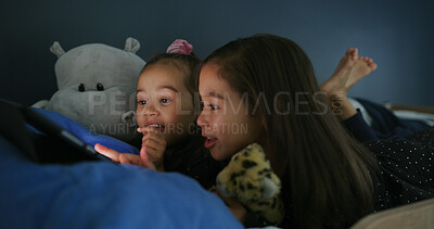Buy stock photo Relax, tablet and children in bedroom for movie, film or video on app for entertainment together. Bonding, night and sisters watching show on streaming website with digital technology in home.
