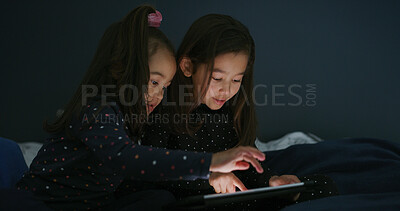 Buy stock photo Relax, tablet and kids in bedroom for movie, film or video on app for entertainment together. Bonding, children and sisters watching show on streaming website with digital technology in home at night