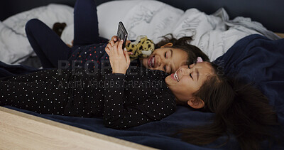 Buy stock photo Relax, smile and phone with kids in bed for streaming, education games and bonding. Learning subscription, connection and sisters or girls in bedroom for family home for child development and web