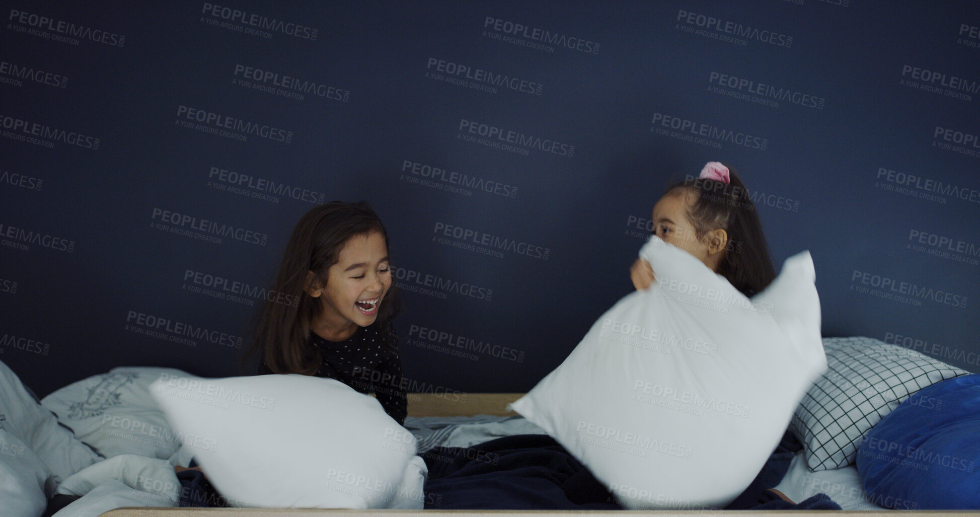 Buy stock photo Pillow fight, laugh and kids in bedroom in home for bonding, connection or relationship. Happy, fun and girl siblings with playing together for childhood memory on bed in morning with excitement.