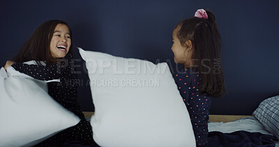 Buy stock photo Pillow fight, happy and kids in bedroom in home for bonding, connection or relationship. Smile, fun and girl siblings with playing together for childhood memory on bed in morning with excitement.