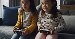 Home, kids and play video game for competition, contest and entertainment on sofa. Sisters, girls and children with console for gaming challenge, hobby and relax together with family in lounge