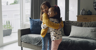 Buy stock photo Hug, love and smile with sister children in living room of home together for affection or bonding. Family, happy and relationship with sibling kids embracing in apartment for safety or security