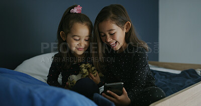 Buy stock photo Relax, laughing and phone with kids in bed for streaming, education games and bonding. Learning subscription, meme and sisters or girls in bedroom for family home for child development, joke and web