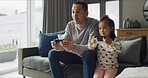 Dad, child and play video game in lounge for competition, contest and entertainment on sofa. Father, girl and kid with console to challenge parent, bonding and relax together with family in home