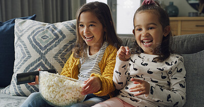 Buy stock photo Happy girl, siblings and watching TV with popcorn on sofa for funny cartoon or movie in home. Child, sisters or kids laughing with snack or remote for online entertainment or subscription in house