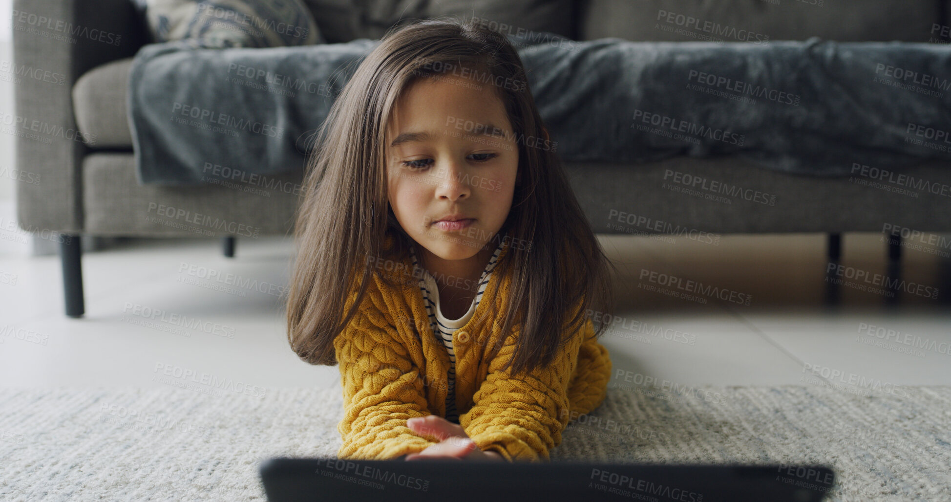 Buy stock photo Tablet, relax and floor with child in home for streaming service, education games and elearning app. Kindergarten cartoons, storytelling subscription and search with girl in living room for study