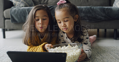 Buy stock photo Children, sister or watching with tablet in home for online entertainment or subscription. People, girl or siblings streaming with technology or popcorn for movie, snack or bonding together on floor