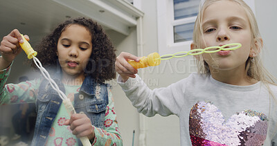 Buy stock photo Friends, kids and blowing bubbles outdoor at home for game, bonding and fun at backyard. Playing, children and girls with soap toys for entertainment, portrait and hobby by house together on weekend