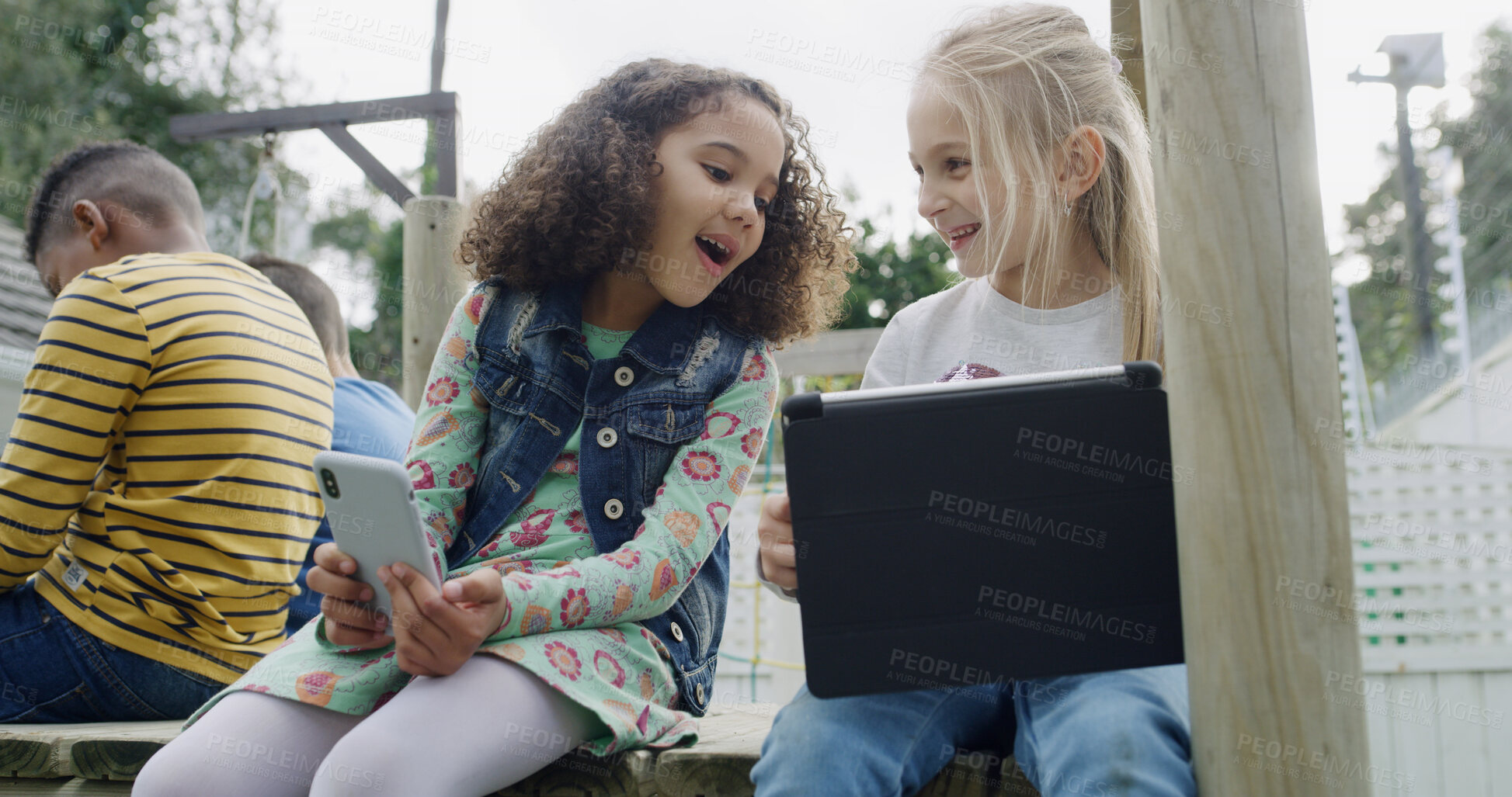 Buy stock photo Friends, children and smile with tech in park for social media, fun and break in backyard. Girls, together and bonding with phone, tablet and internet for school holiday in playground with games