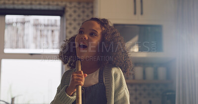 Buy stock photo Singing, broom and child in kitchen for fun, music and happy while cleaning in home. Playful, childhood and girl with energy, karaoke and song for housekeeping, chore routine and hygiene on weekend