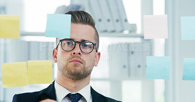 Buy stock photo Glass wall, sticky notes and solution with business man in office for brainstorming or development. Planning, storyboard and vision with employee in workplace for problem solving or strategy