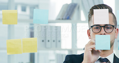 Buy stock photo Glass wall, sticky notes and writing with business man in office for brainstorming or solution. Development, mindmap and storyboard with employee in workplace for problem solving, strategy or vision