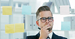 Sticky notes, storyboard and thinking with business man in office for brainstorming or solution. Development, glass wall and planning with employee in workplace for problem solving or strategy