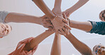 Business people, meeting and team with hands together below in huddle for mission or collaboration. Low angle, group or employees with pile or stack in solidarity for trust, commitment or support