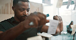 Sticky note, black man and glass for planning, ideas or schedule for project management in office. Brainstorming, strategy and male employee by board for calendar, agenda and research at workplace