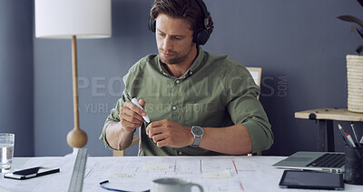 Buy stock photo Floor plan, marker and architect with headphones, blueprint and engineer in office. Laptop, podcast and illustration with architecture notes for construction project with design for contractor