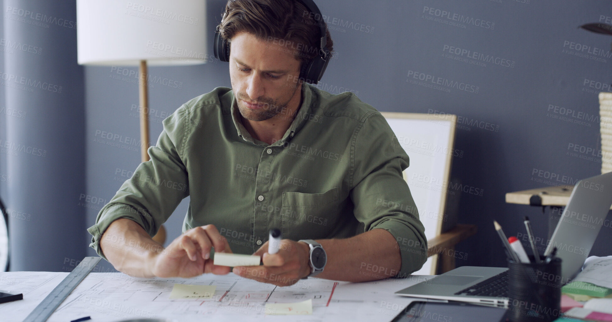 Buy stock photo Architect, headphones or man with planning on blueprint for building layout, design ideas or strategy. Architecture, person or sticky notes with music at desk for construction guide or project review