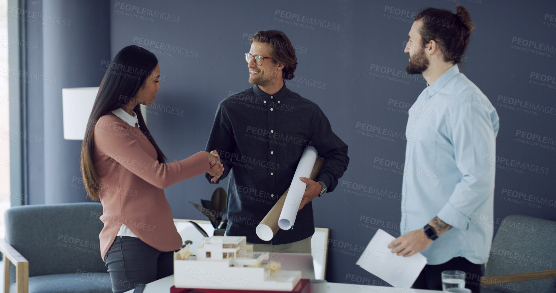 Buy stock photo Business people, smile and handshake with blueprint, documents or architecture model in office. Men, woman and meeting for design, engineering team and welcome or approval for 3D building prototype