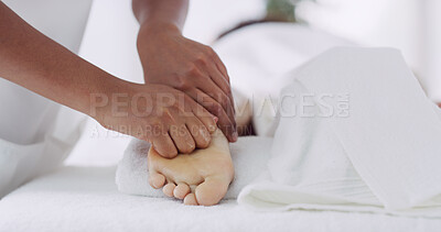 Buy stock photo Hands, foot massage and relax on spa bed for treatment, circulation and care at luxury resort. Person, masseuse and client with physical therapy, pressure point and feet with break at wellness lodge