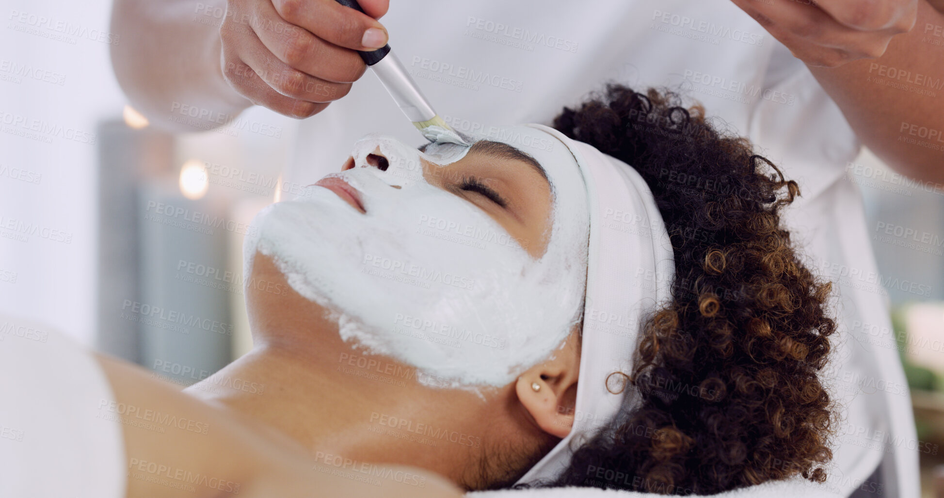 Buy stock photo Hand, brush and woman for clay mask at spa, beautician and client with self care, skincare and face wellness. Facial, treatment and beauty with antiaging, moisturizing and skin detox at health resort