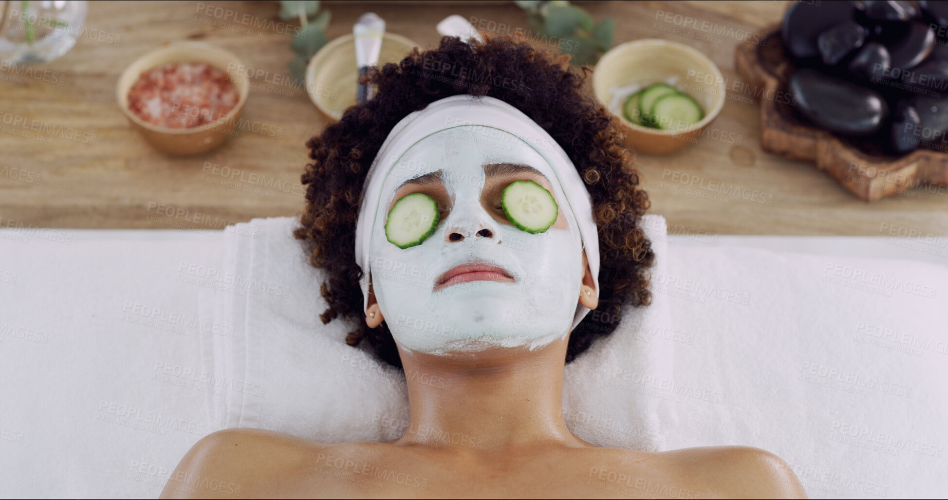 Buy stock photo Woman, face mask and cucumber at spa for beauty, relax and wellness with treatment for skincare. Girl, above and facial cream with organic fruit for benefits, anti aging or dermatology at resort