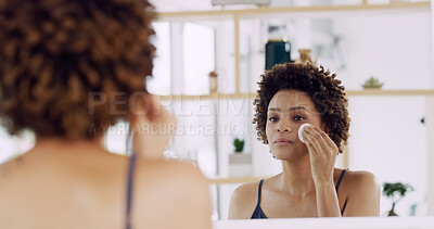 Buy stock photo Woman, mirror and pad for skincare at house for makeup removal, skin toner and facial clean. African person, reflection and wipe face with cosmetic product, treatment glow and dermatology benefits